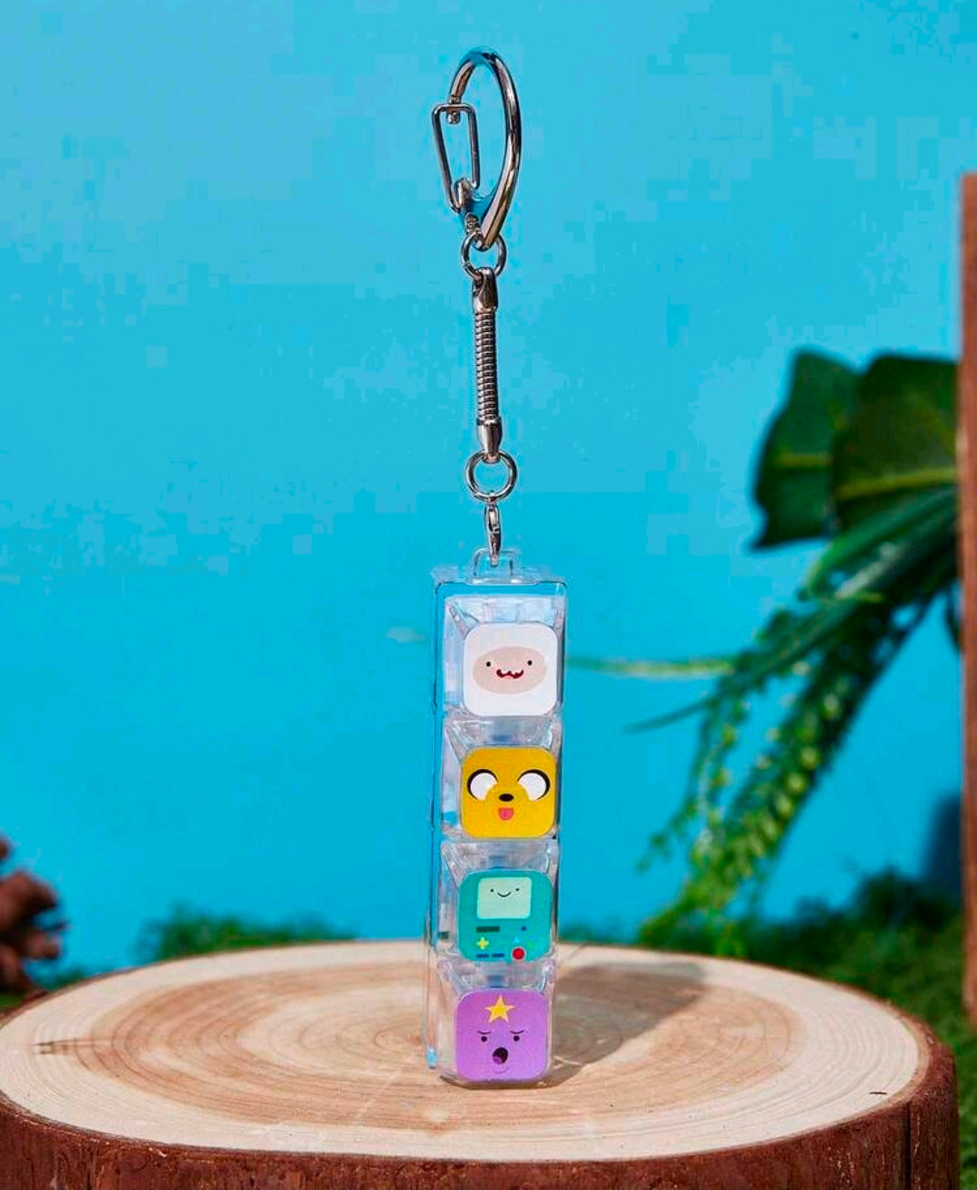 Clear clicker keychain with four character blocks and dangling metal key ring