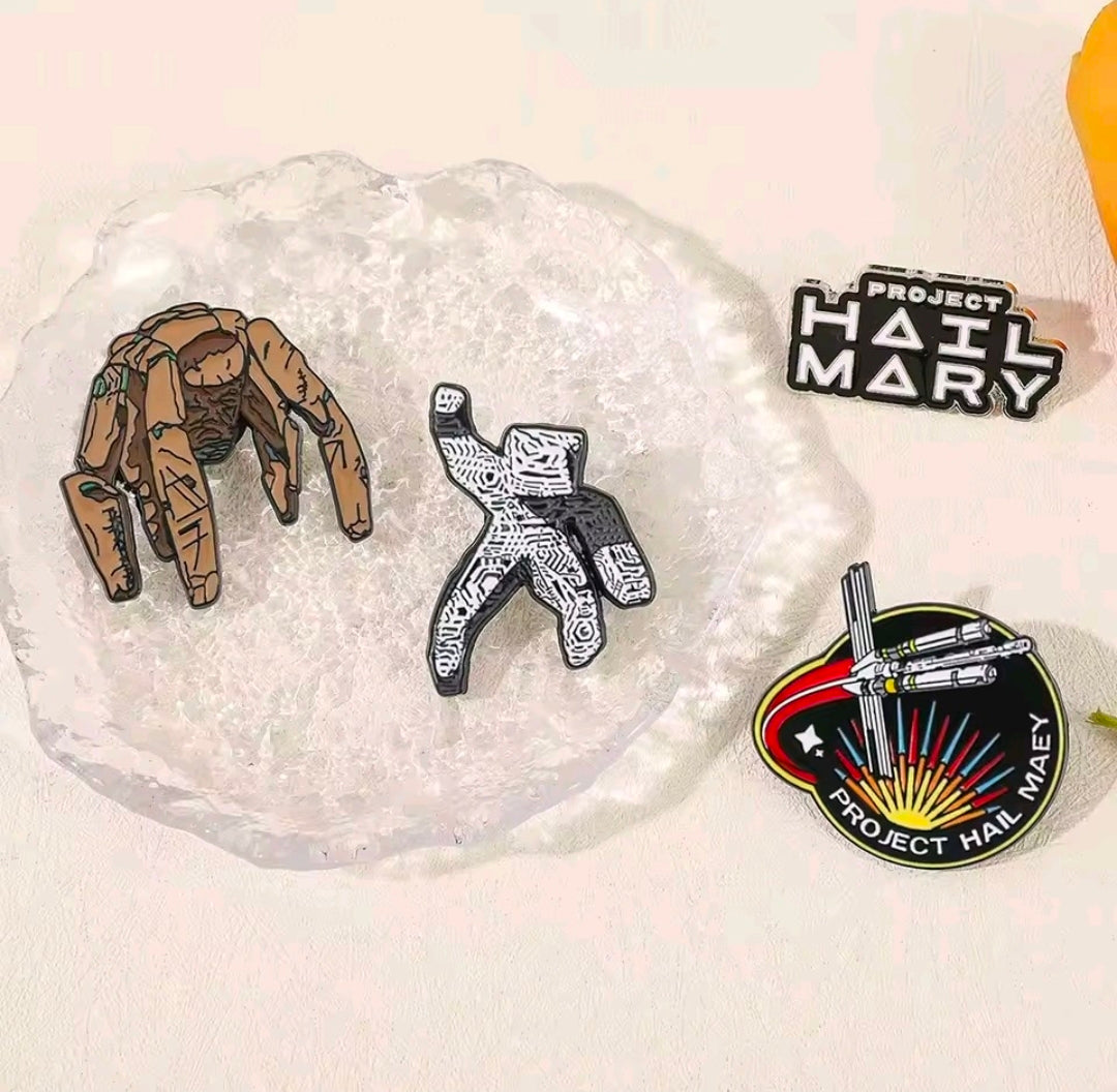 4-piece enamel pin set on a plate with two character figures, a text logo, and ship badge