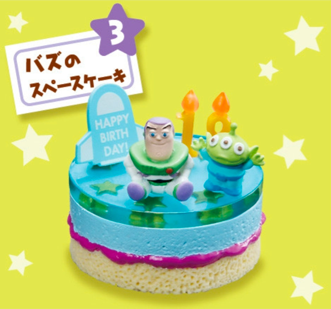 Mini cake figure with Buzz and green alien, two orange candles, birthday sign