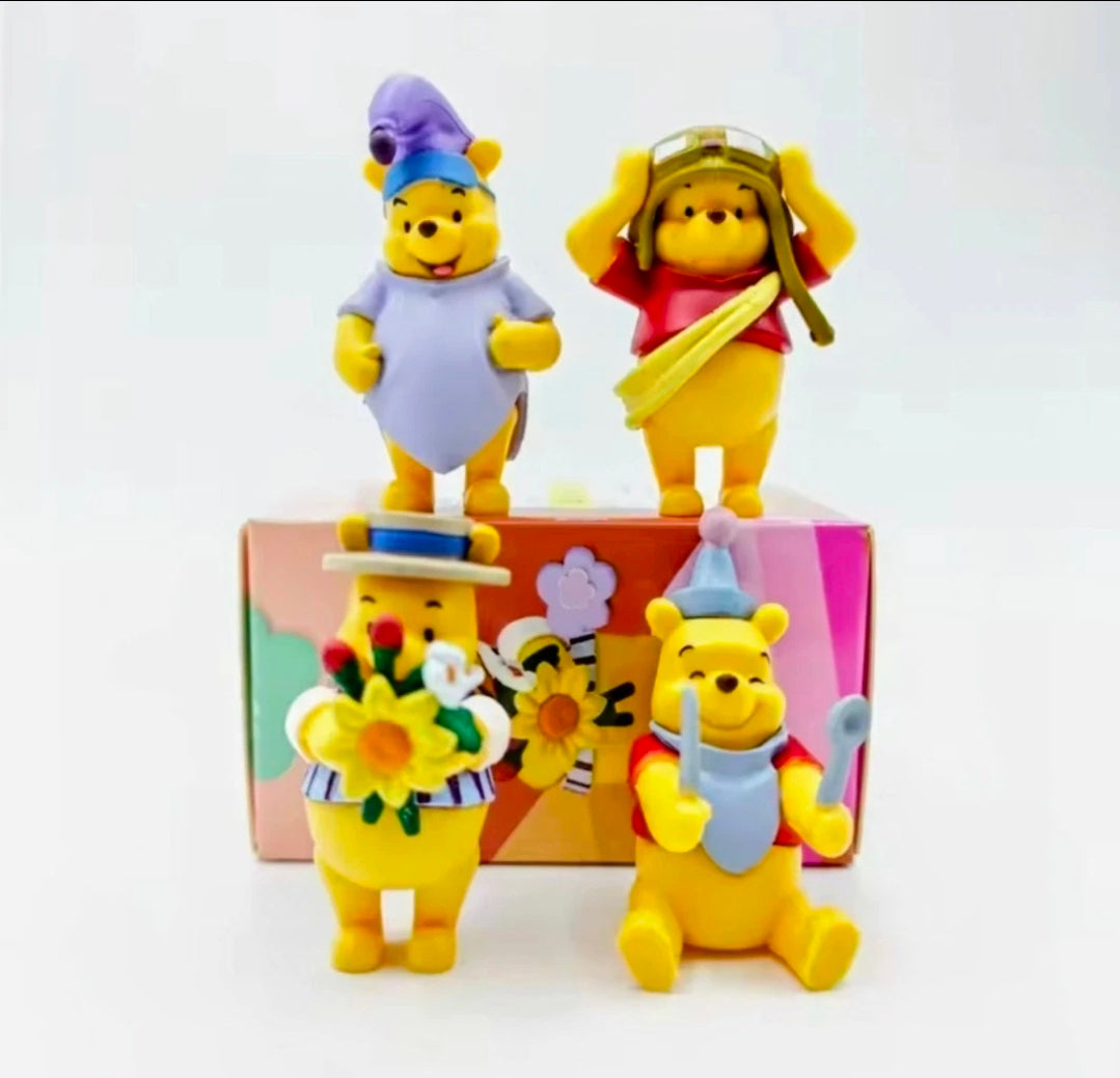 Winnie the Pooh character figures posed around the box, bouquet and hats visible
