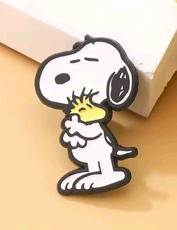 Snoopy dog enamel pin with headphones, black outlines and small yellow star