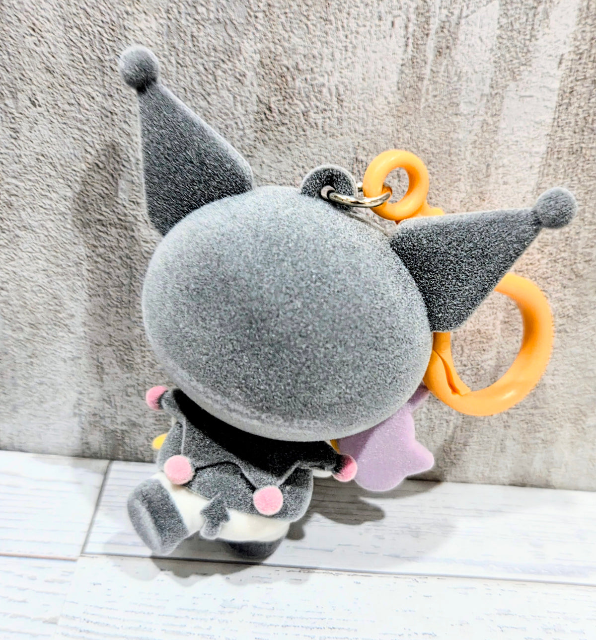 Kuromi grey plush bag clip with orange key ring and purple wing accents