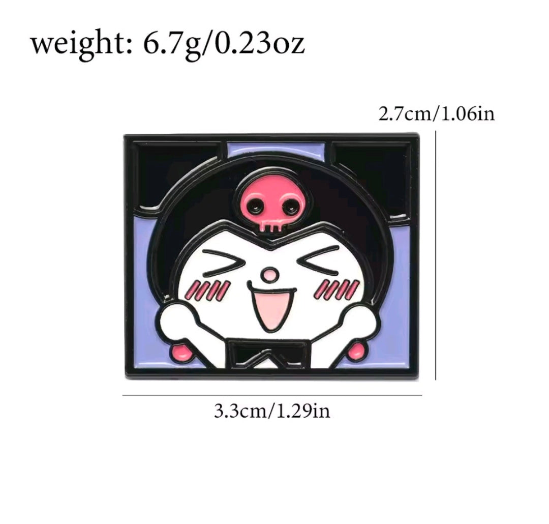 Kuromi enamel pin with pink skull face and raised hands, dark background, black frame