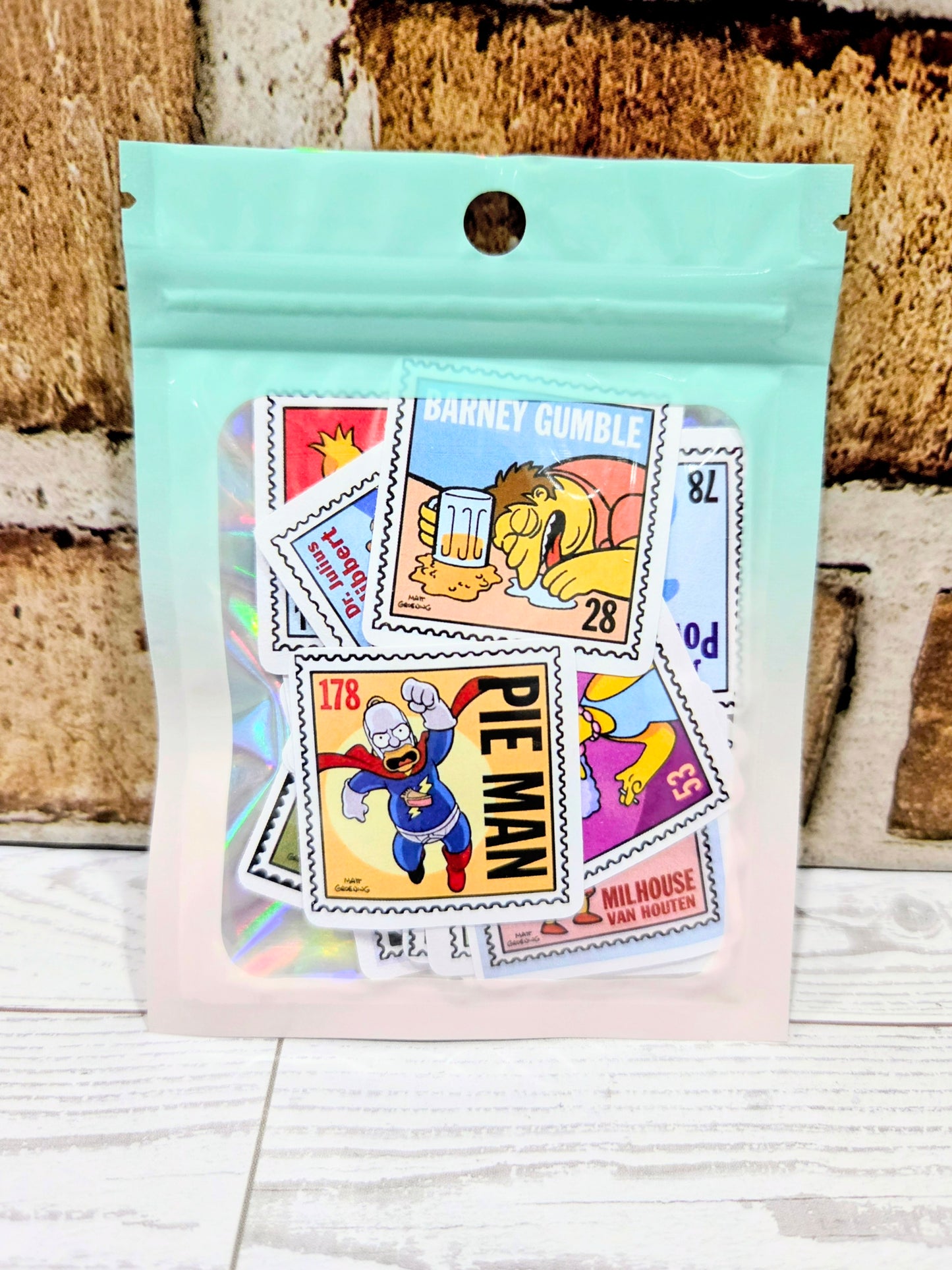 Sticker pack bag with assorted Simpsons postage-stamp style character decals, colorful stamps