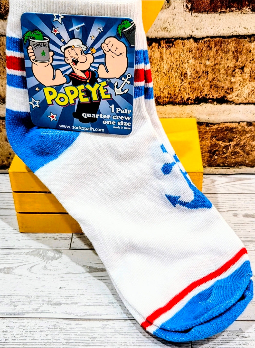 Quarter crew socks with Popeye character graphic and blue-white-red stripe pattern