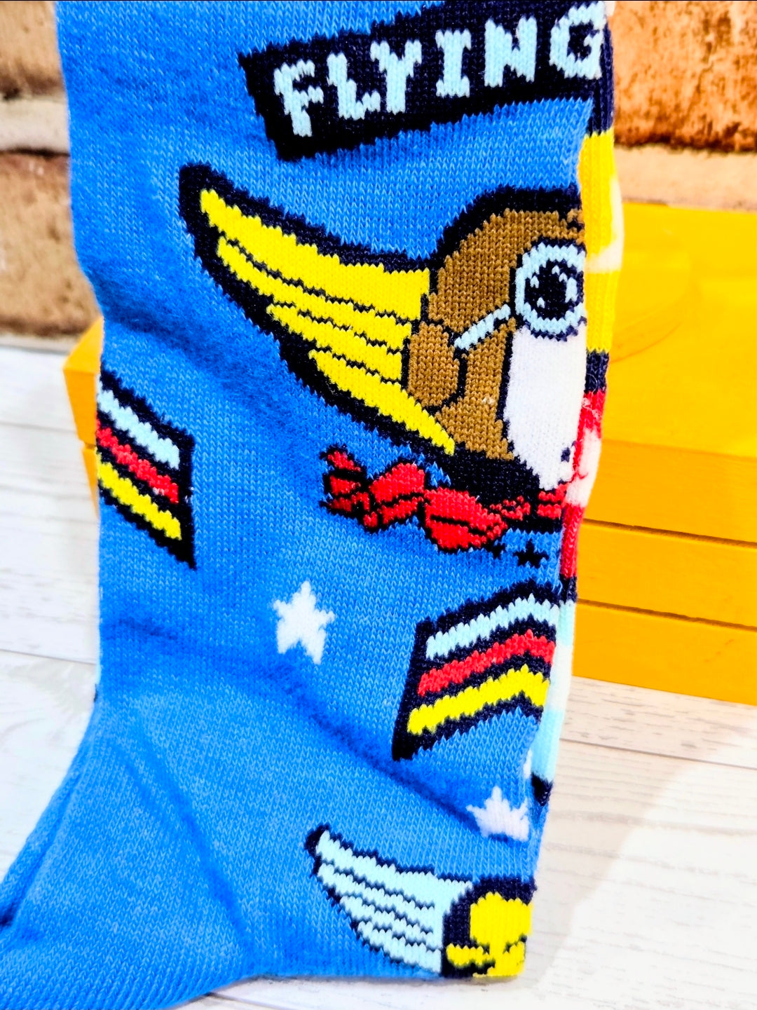 Blue crew sock with Snoopy flying ace face and “FLYING” lettering