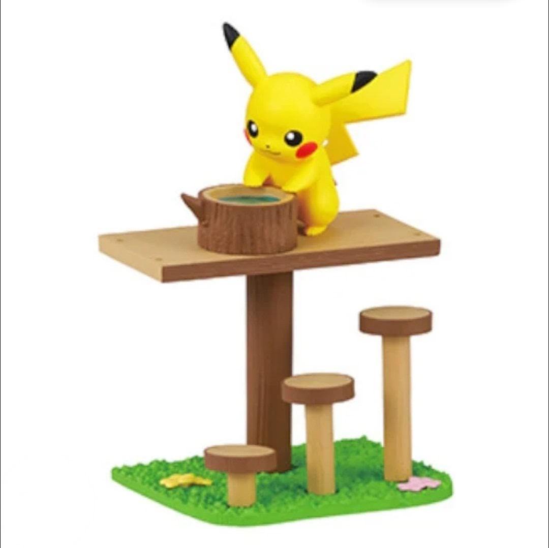 Pokemon mini figure stump table playset with Pikachu-like figure beside a wooden cup