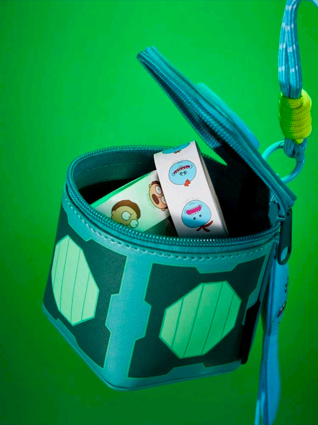 Teal change bag open with cards inside; Meeseeks charm and zipper