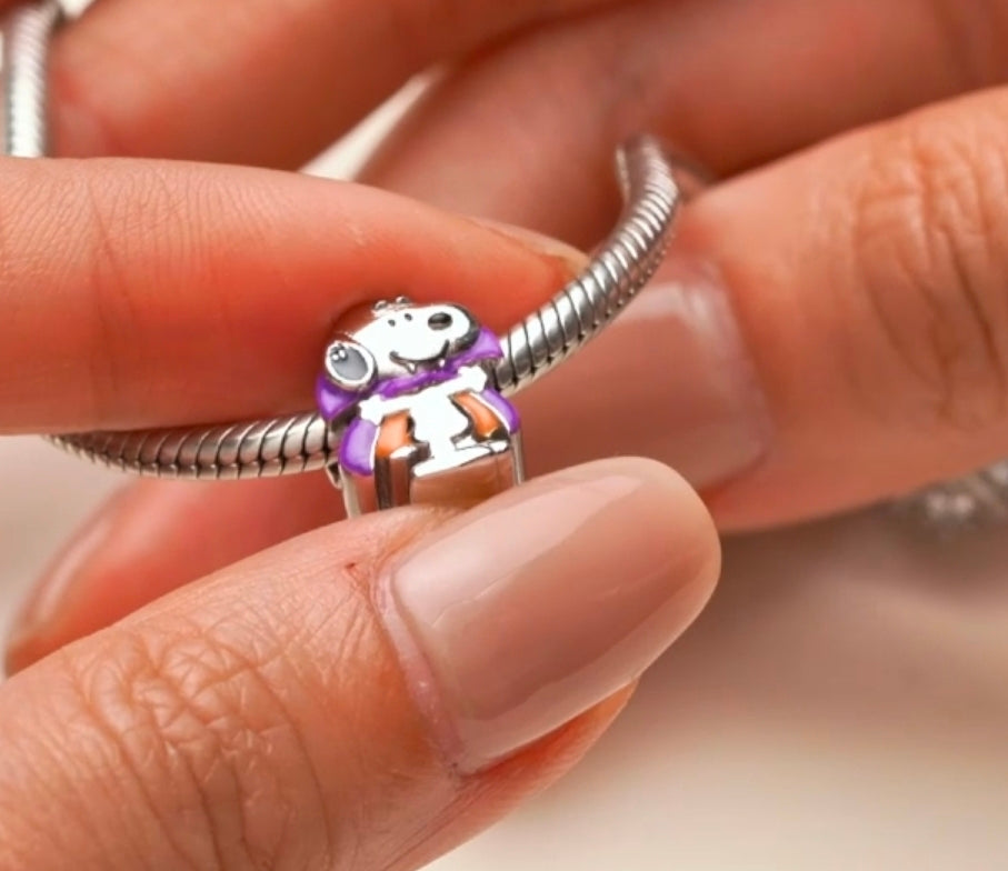 Silver bracelet charm bead of Snoopy in a purple cape and orange outfit