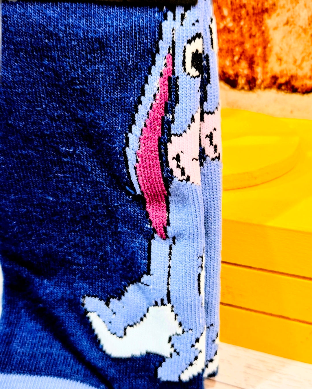 Blue crew sock with Eeyore face and ear patch embroidery on side