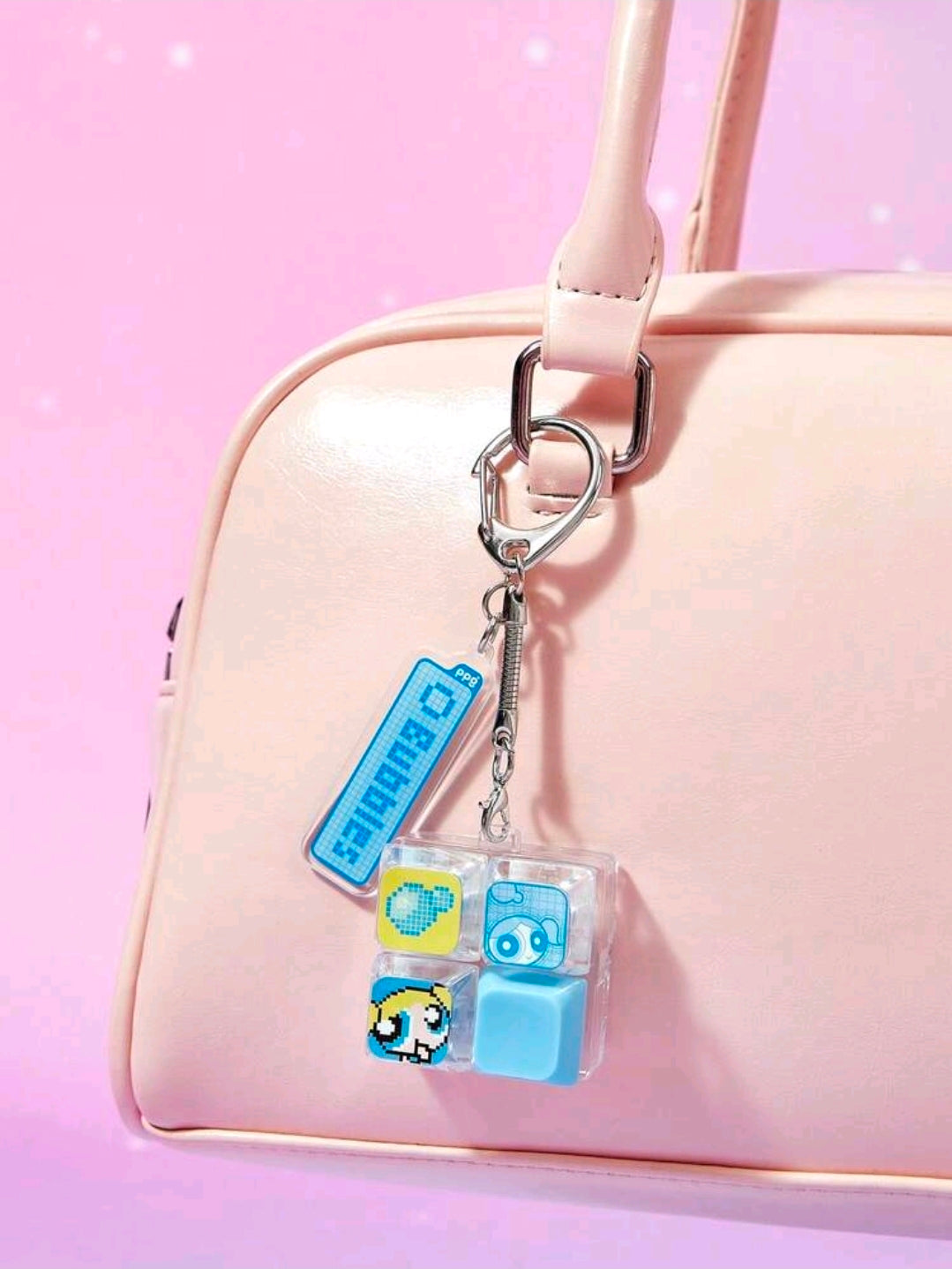 Light pink bag keychain with blue keyboard clicker charm and clear block fidget