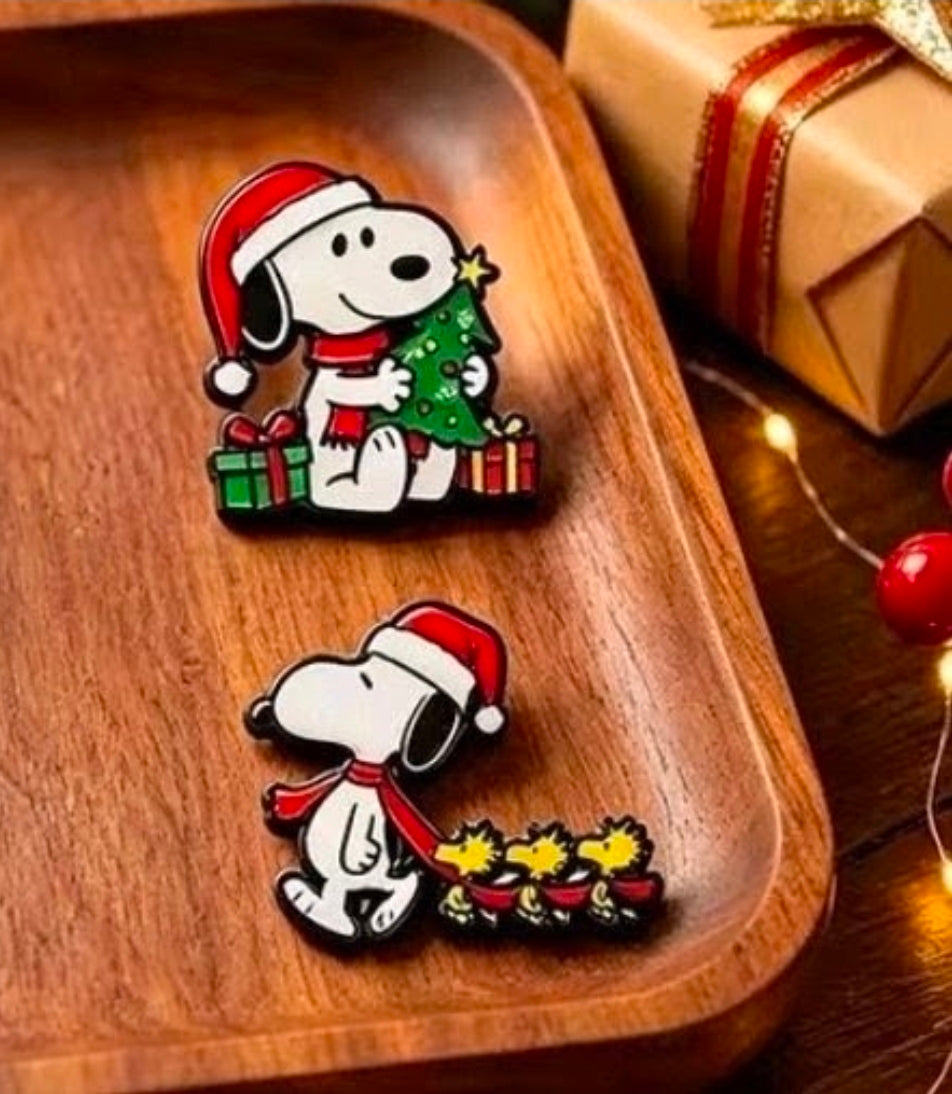 Snoopy Christmas enamel pins on wood: tree with gifts and sleigh star ornaments