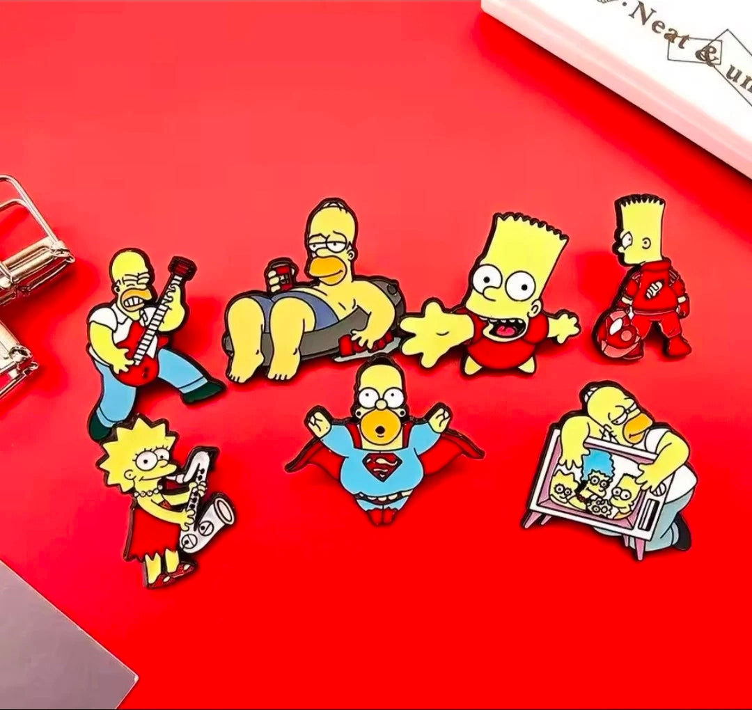 Simpsons enamel pin set with seven character pins in a scattered layout