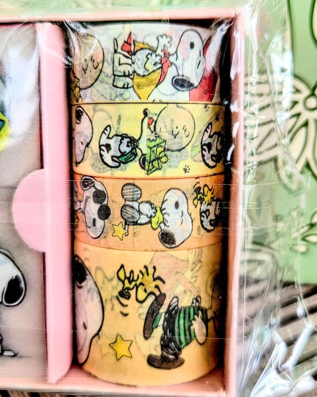 Washi tape roll with Peanuts characters, stars, and playful doodle patterns