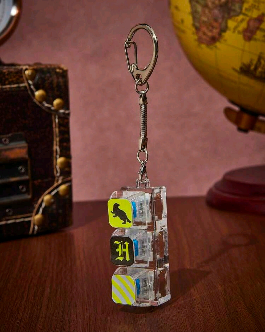 Acrylic Hufflepuff fidget keychain charm with metal keyring, chain, and striped tiles