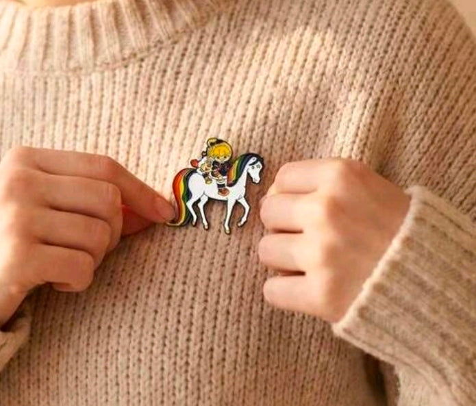 Enamel riding duo pin set of 2, showing blond girl on a white horse with rainbow mane