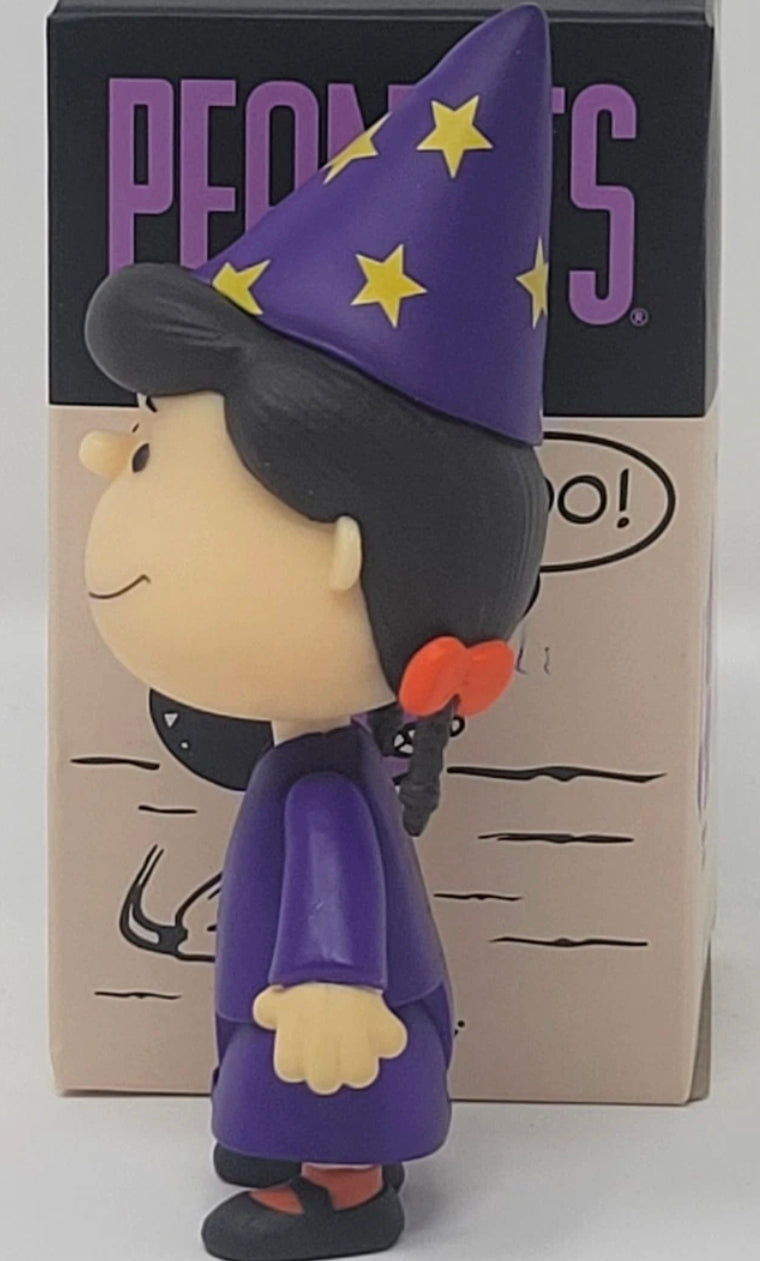 Side view Halloween vinyl figure with a purple wizard hat and long purple robe with stars