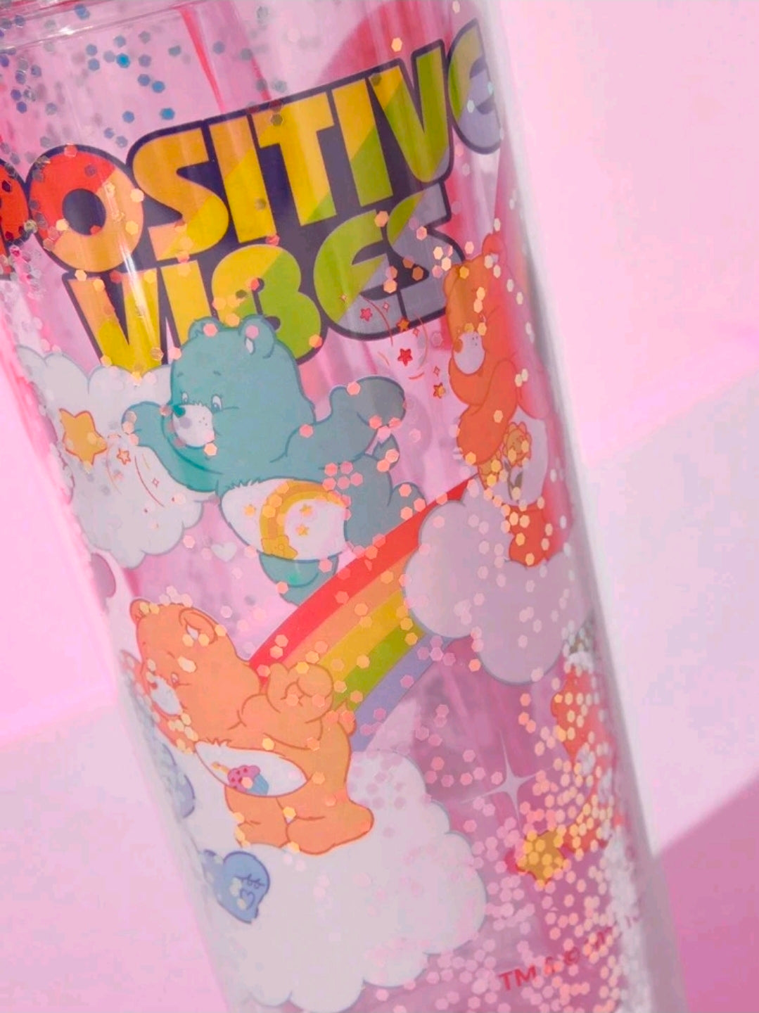 Glitter tumbler cup with straw, multicolor Care Bears positive vibes print.
