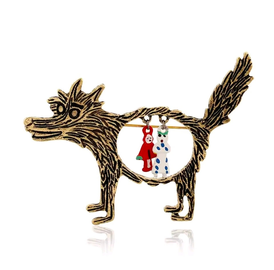 Gold-tone enamel wolf brooch pin with circular Red Riding Hood and grandma charms.