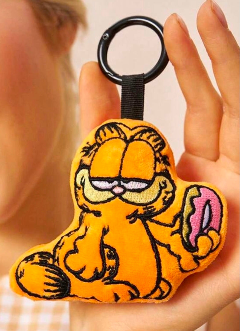 Orange Garfield mini plush keychain held in hand with black key ring