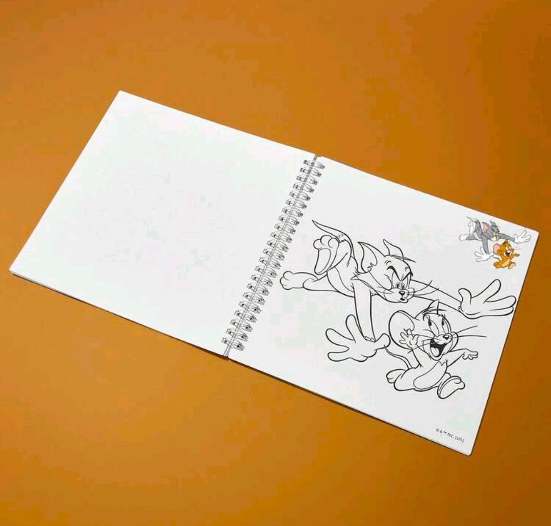 Open coloring book with blank page and black line art of Tom and Jerry on right