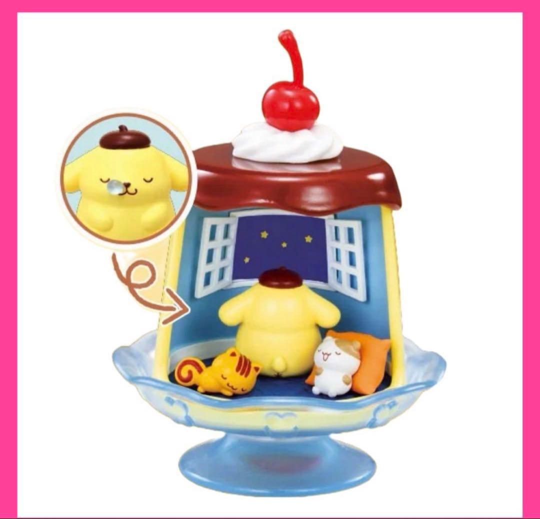 Mini collectible figure on blue stand with maroon roof, red cherry top, Pompompurin and cat
