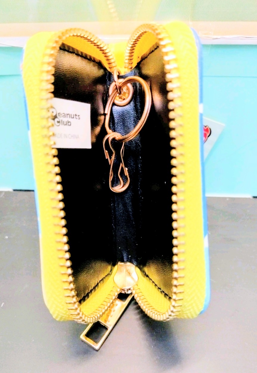 Blue smart key case with yellow trim, black interior, and metal keyring latch