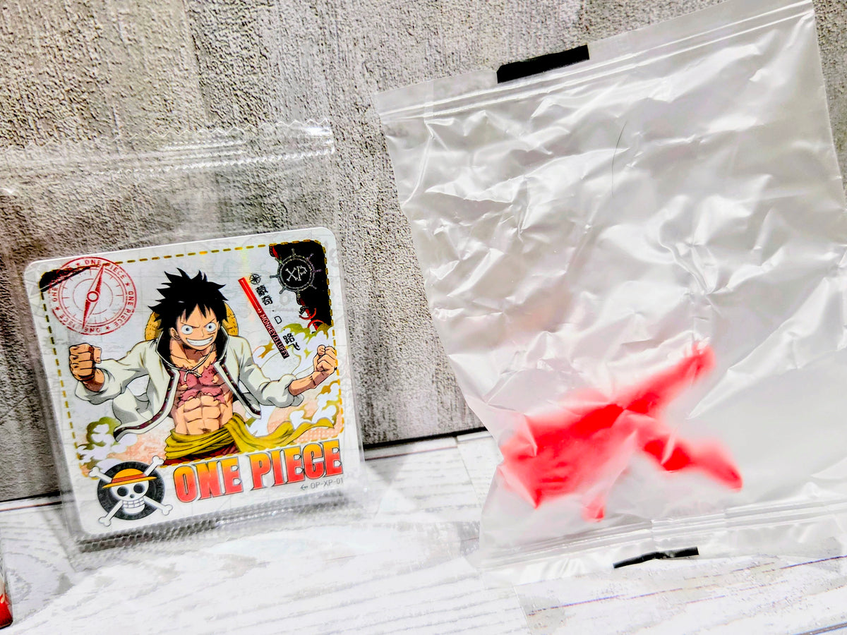 Sealed bag with small red collectible figure and One Piece character card