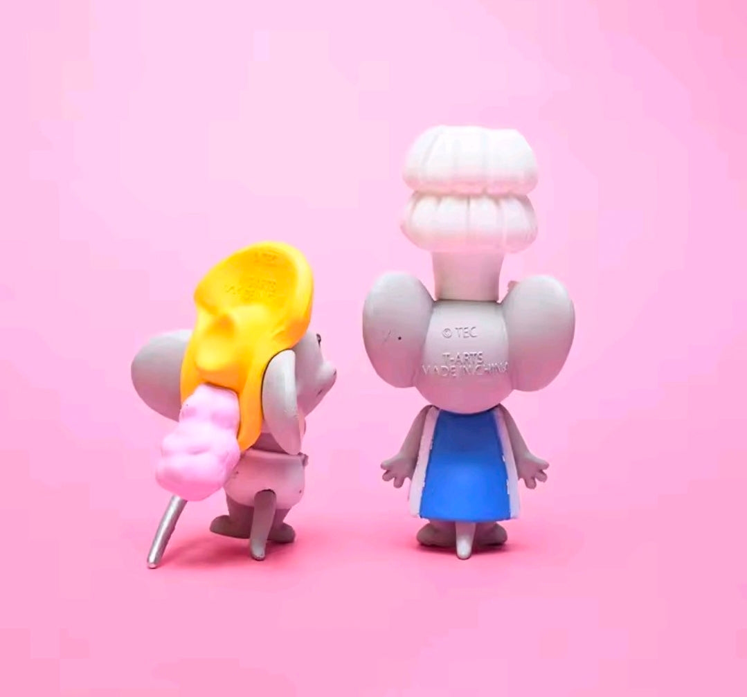 Two Tom & Jerry mini figurines: yellow-hatted character and pink chef with white hat