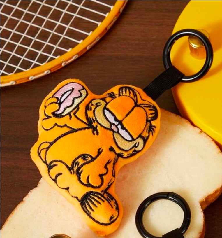 Orange Garfield mini plush keychain close-up with black key ring and stitched face
