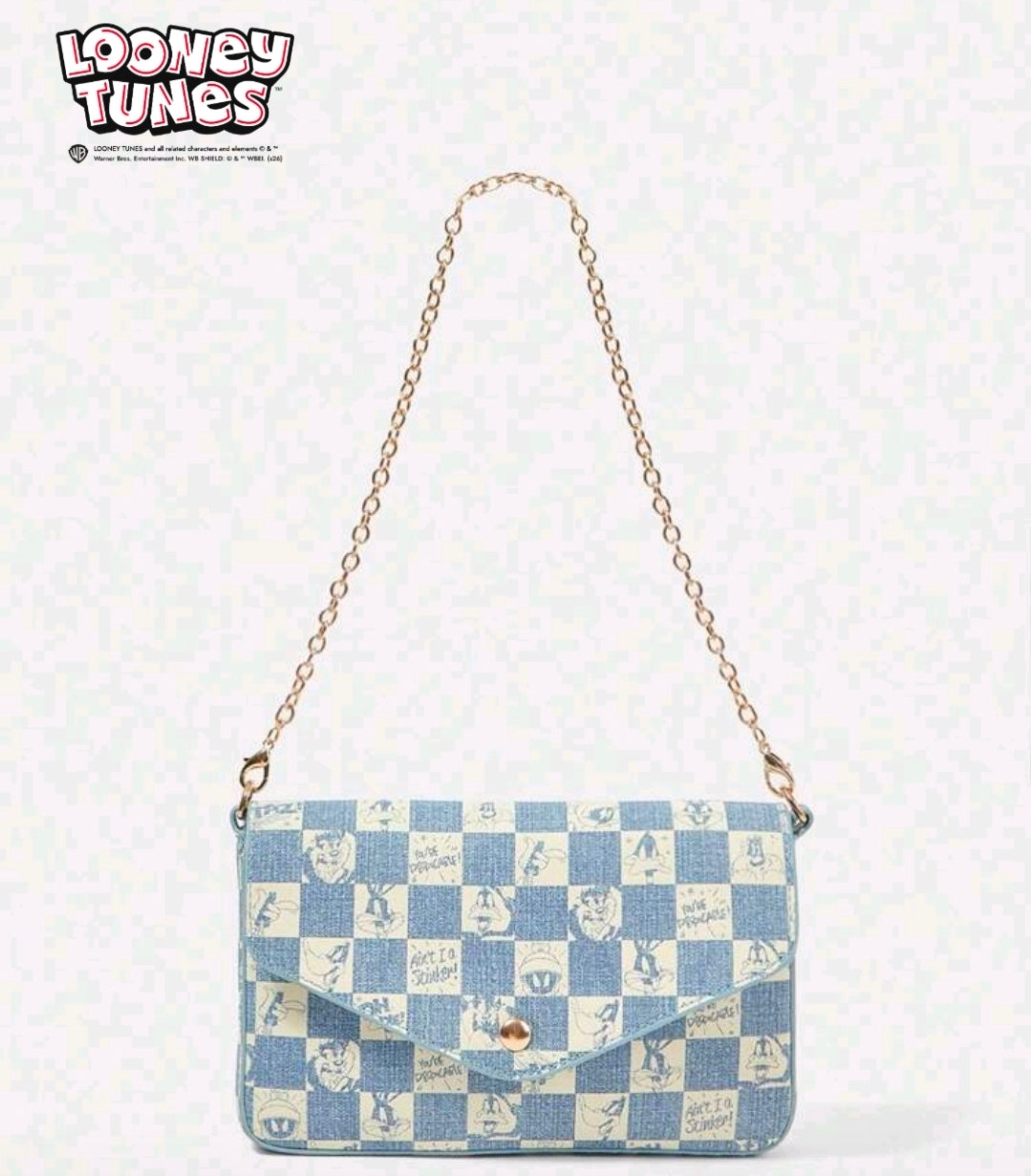 Denim blue patchwork shoulder bag with gold chain and round snap button.
