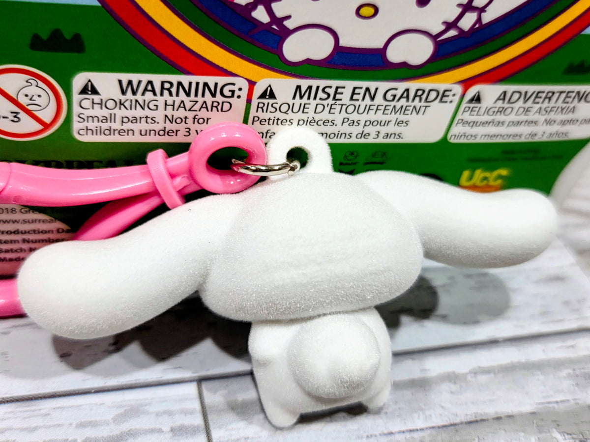 White flocked Hello Kitty character keychain with pink ring, side view.