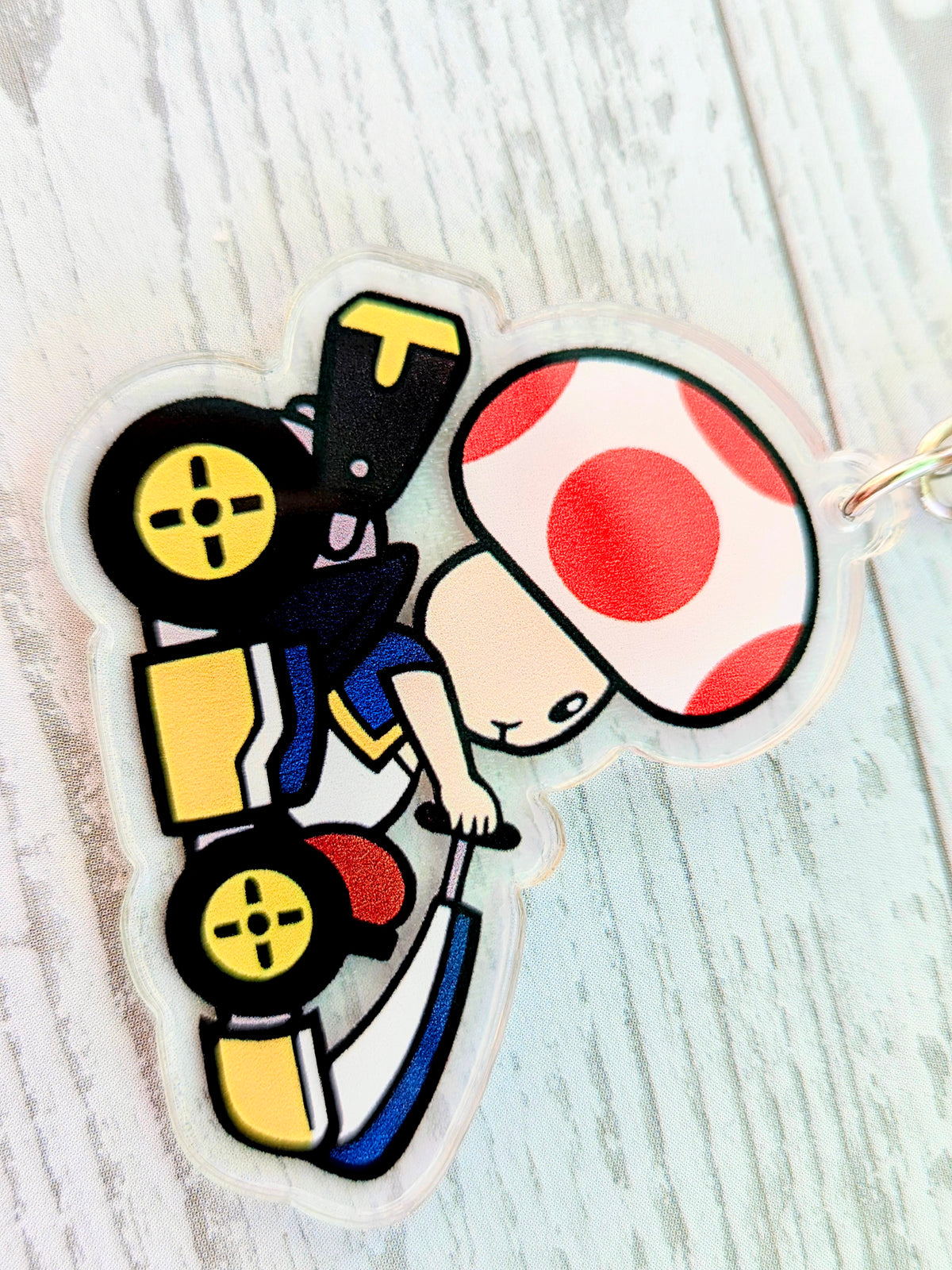 Acrylic die-cut keychain featuring Toad in a red-spotted helmet with gold keyring