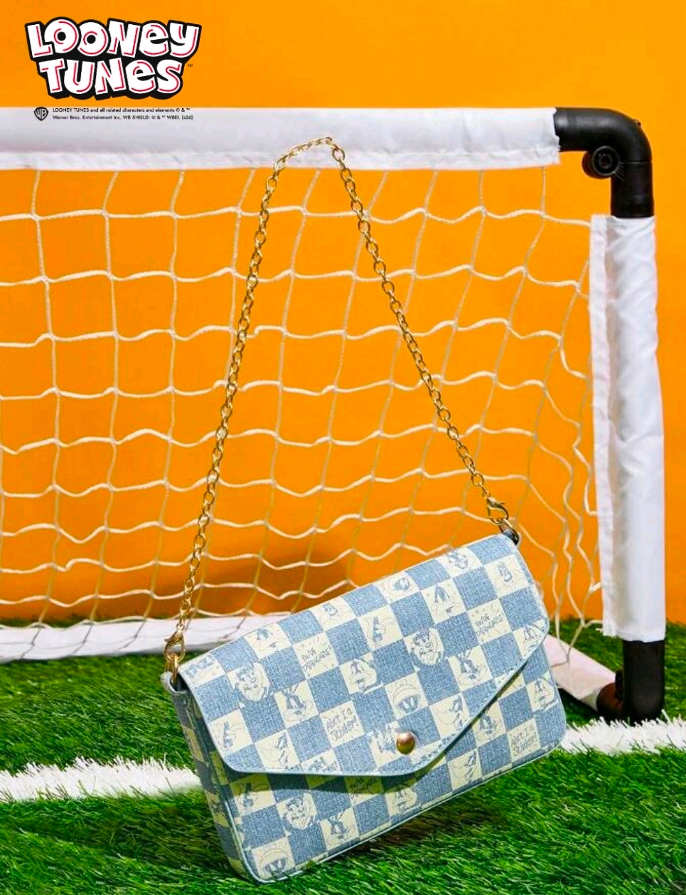 Denim blue checker-pattern shoulder bag with gold chain strap and snap flap.