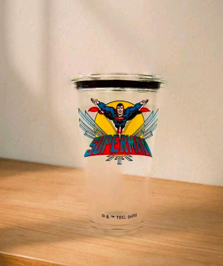 Clear Superman tumbler with black lid, shown on tabletop.