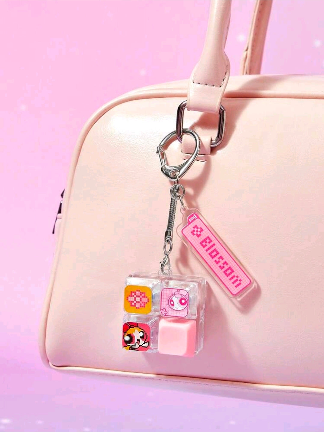 Clear keychain fidget charm with pink tag and metal clip on strap