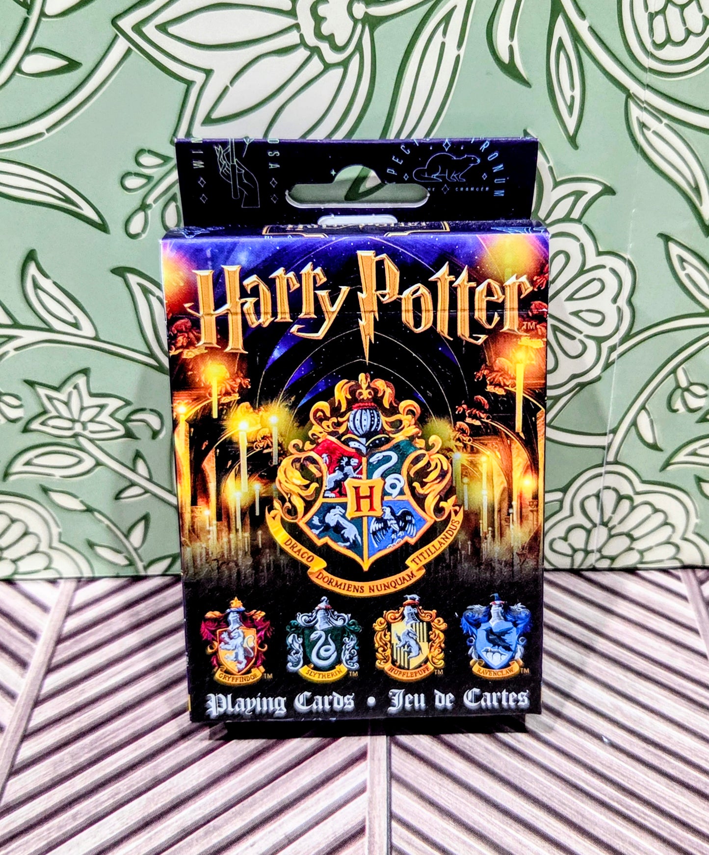 Playing cards deck box with Harry Potter title, Hogwarts crest, and card illustrations