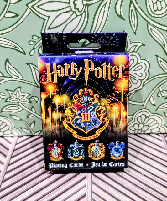 Playing cards deck box with Harry Potter title, Hogwarts crest, and card illustrations