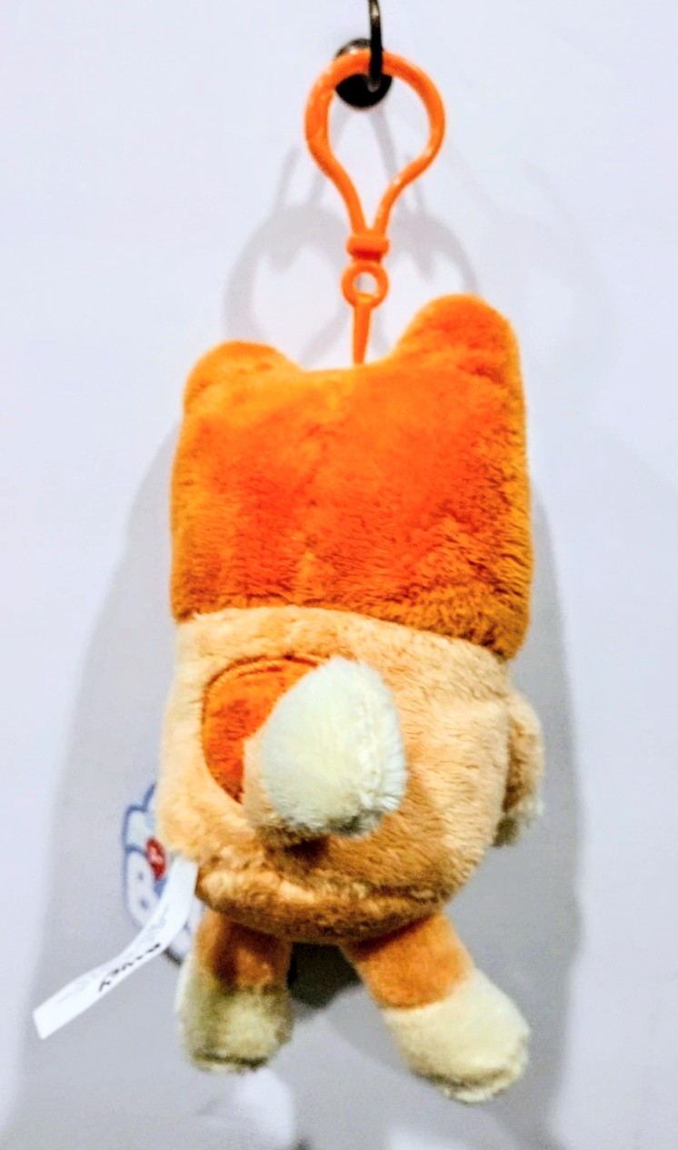 Orange and white Halloween plush keychain with pumpkin-style smiling face and key ring