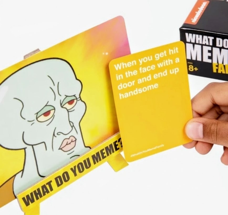 Hand holding an orange prompt card with SpongeBob SquarePants character artwork
