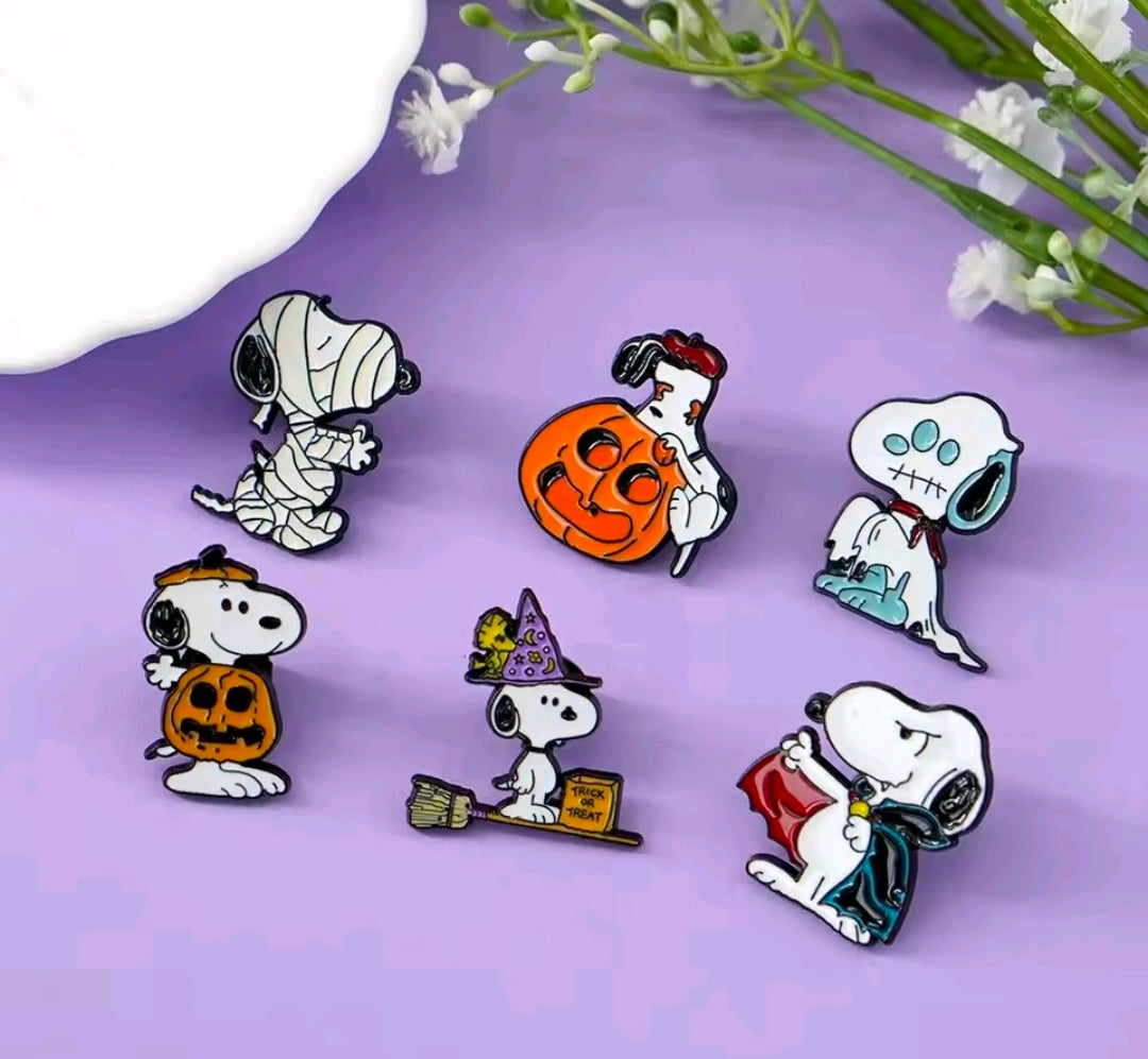 Snoopy Halloween enamel pin set of six pins, arranged to show ghost, pumpkin, witch, and bat.