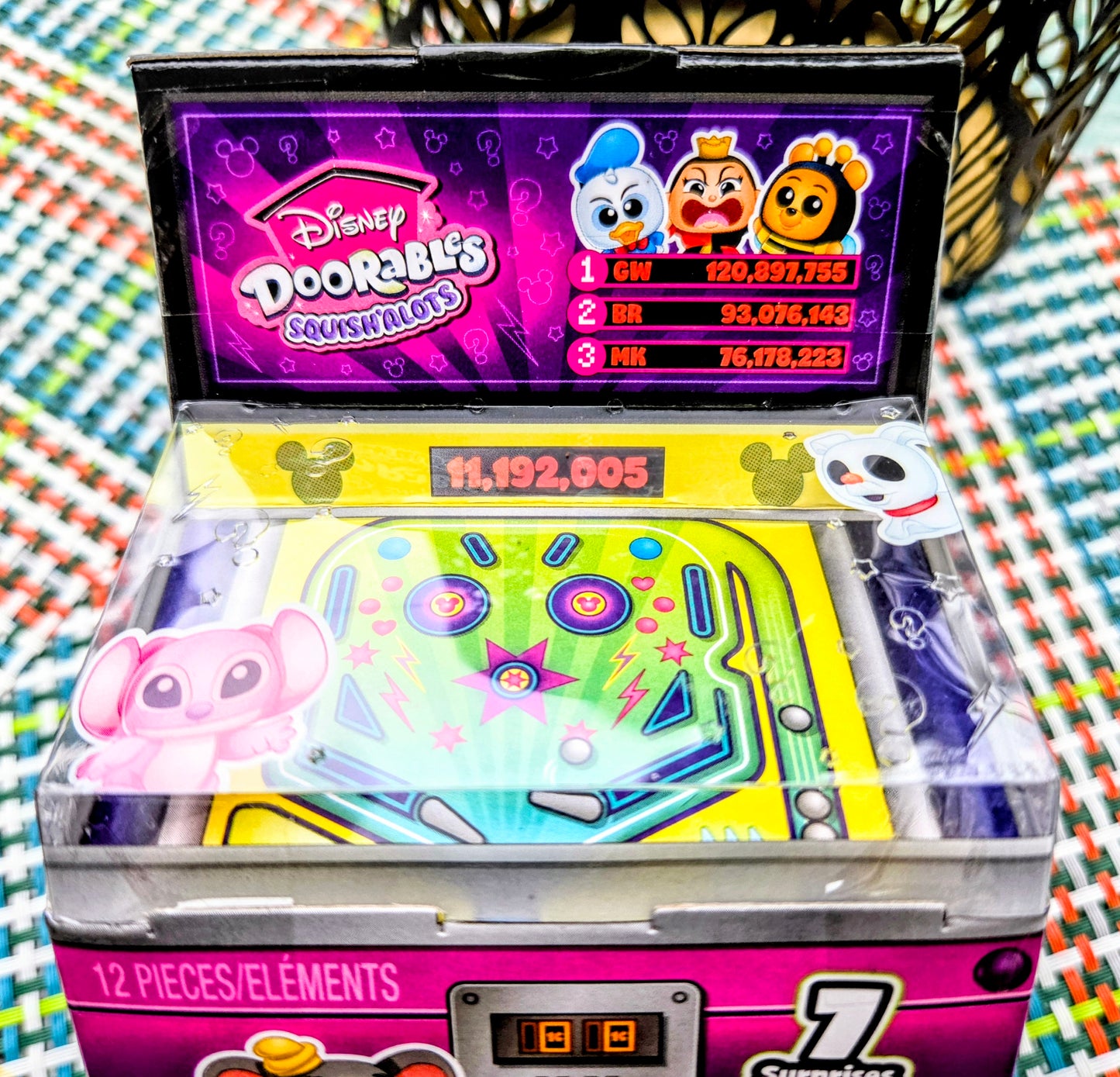 Neon green Pop N' Pinball toy board with pink Squish'alots character and clear pieces