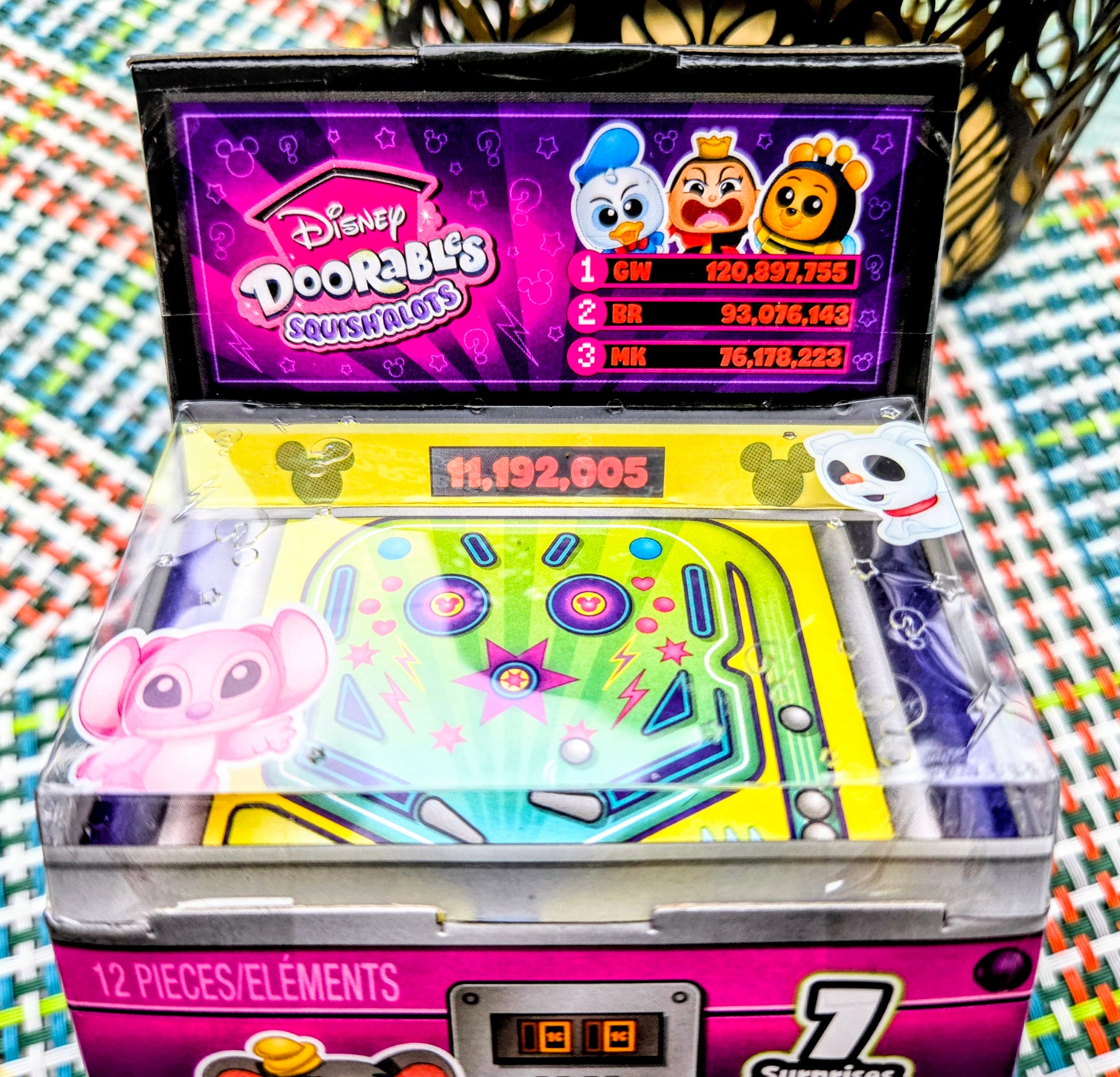 Neon green Pop N' Pinball toy board with pink Squish'alots character and clear pieces