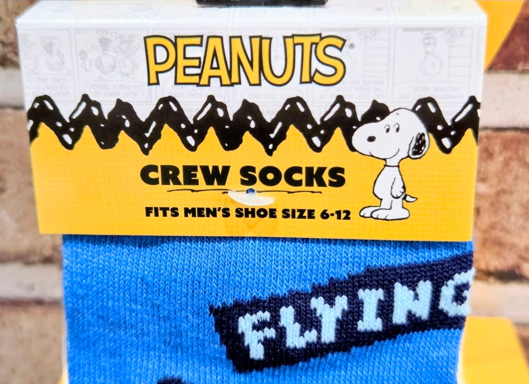 Blue crew socks with Snoopy “FLYING” lettering and white star accents