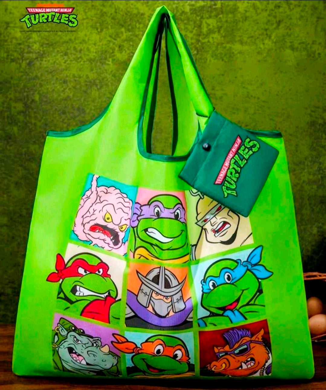 Green TMNT character tote bag with keychain pouch accessory and colorful grid artwork