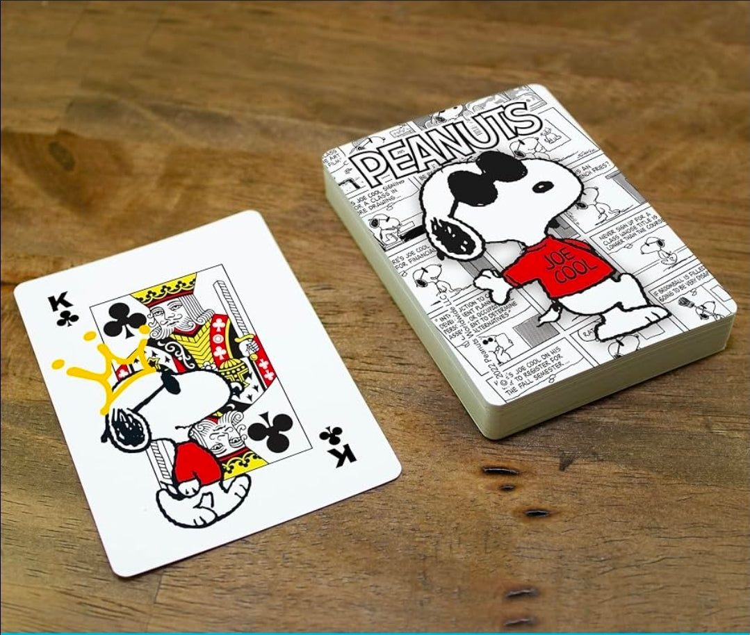 Snoopy Joe Cool playing cards deck with K of clubs card on table