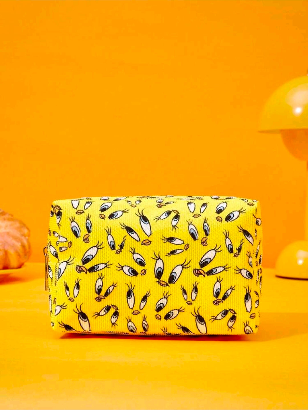 Rectangular yellow makeup pouch with all-over Tweety character face pattern
