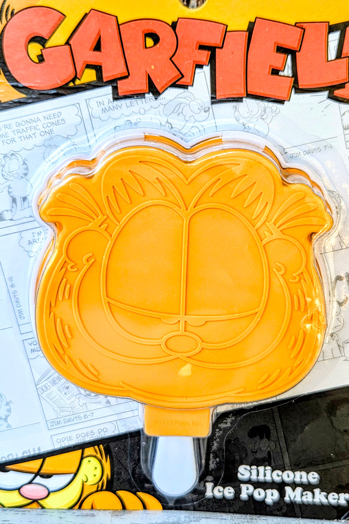 Orange silicone ice pop maker mold with face shape and four compartments