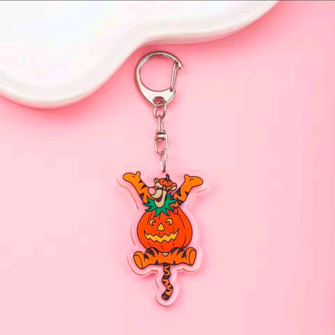 Acrylic Halloween keychain with carabiner; pumpkin-capped character charm in orange and green.