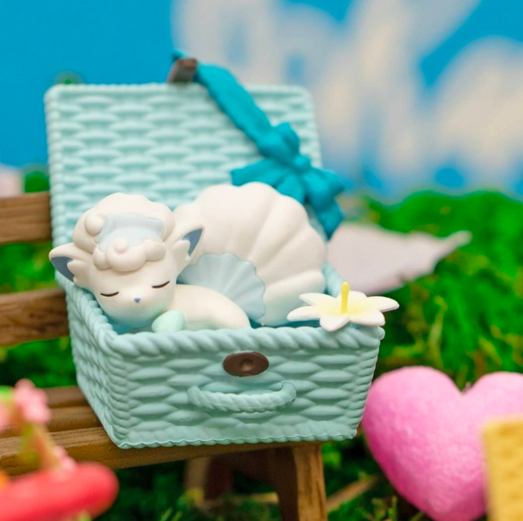 Bulbasaur nap basket figure with white blanket, green body, and lily detail.